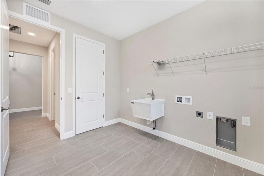 Large laundry room could accomadate cabinetry and extra refrigerator