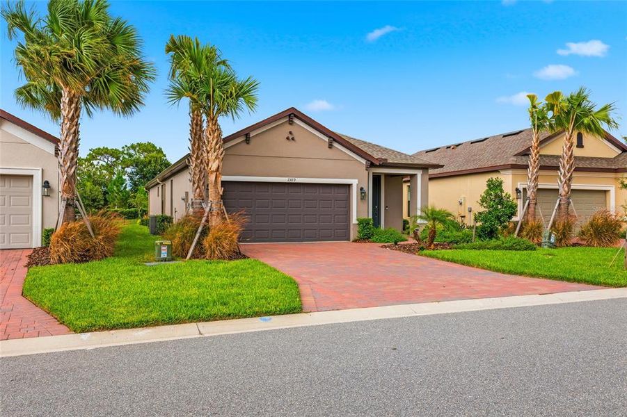 Front exterior of a new home in , Poinciana, FL, highlighting curb appeal (Image 22).