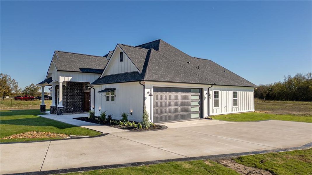 View of side of home with a yard