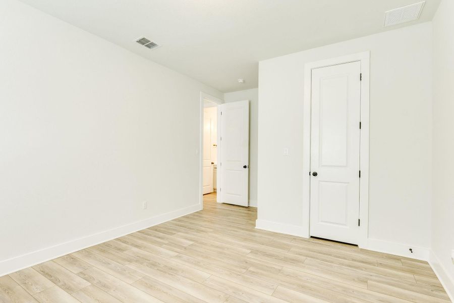 Unfurnished bedroom with light wood-type flooring and baseboards