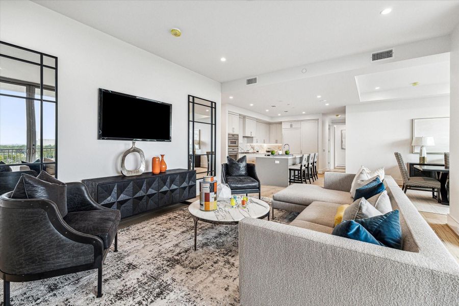 Effortless flow between the living, dining, and kitchen areas in this thoughtfully designed open-concept floor plan. Photos are of a similar unit with the same floor plan