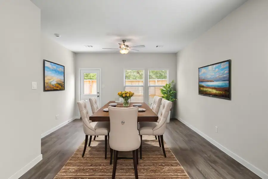 A dining room table with chairs.