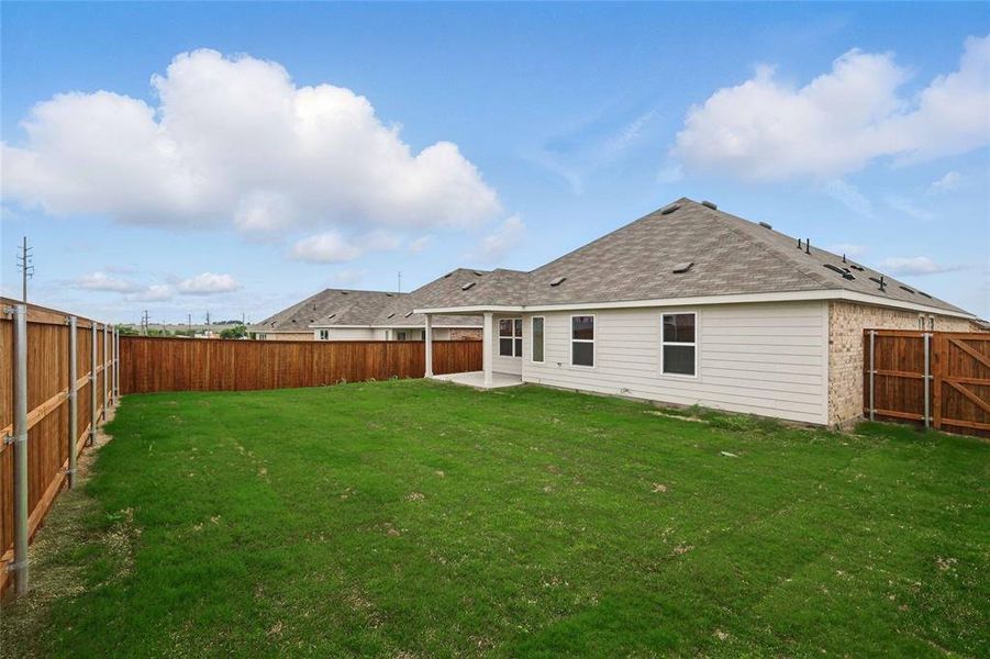 Rear view of house featuring a patio, a fenced backyard, a gate, and a shingled roof Rear view of house featuring a patio, a fenced backyard, a gate, and a shingled roof