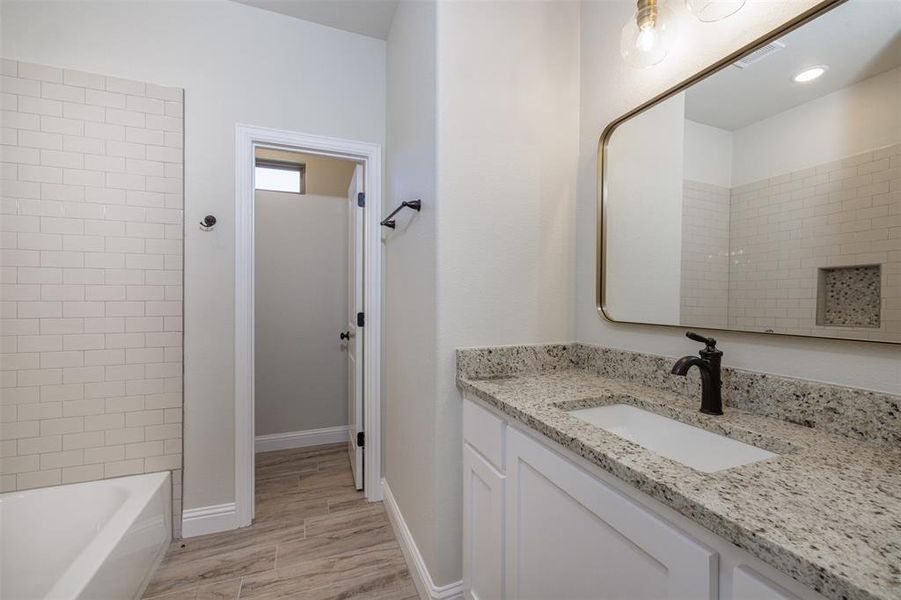 Bathroom featuring vanity and hardwood / wood-style floors