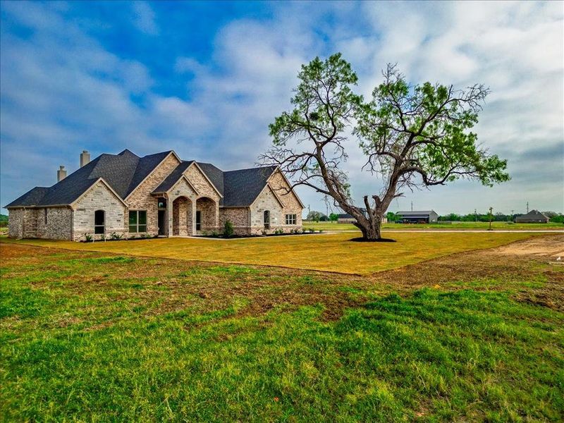 Front exterior of a new home in , Granbury, TX, highlighting curb appeal (Image 1). Front exterior of a new home in , Granbury, TX, highlighting curb appeal (Image 1).