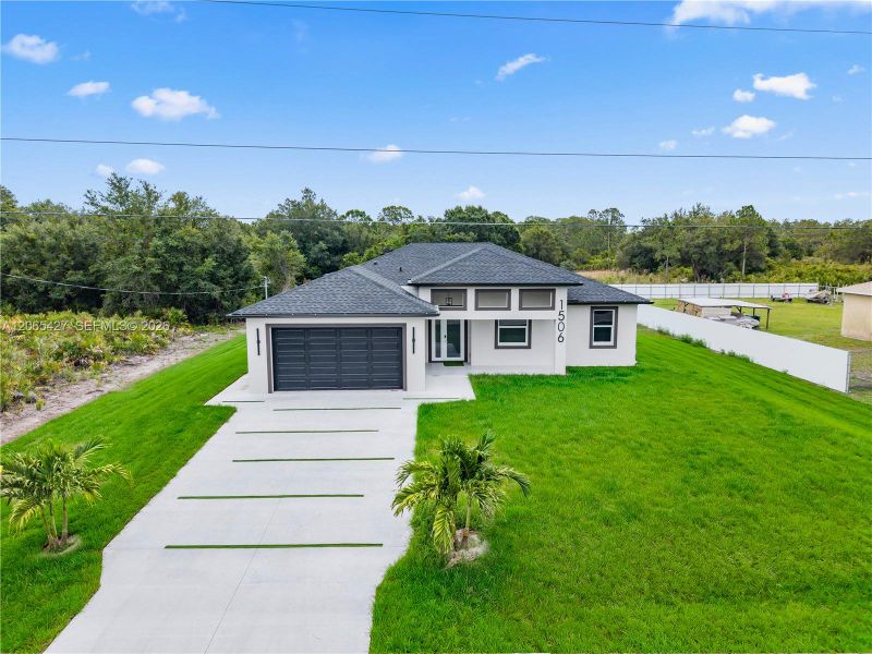 Front exterior of a new home in , Lehigh Acres, FL, highlighting curb appeal (Image 1). Front exterior of a new home in , Lehigh Acres, FL, highlighting curb appeal (Image 1).