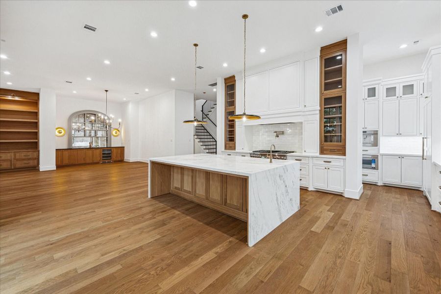 Tucked just beyond the main kitchen, a fully integrated prep area offers a panel-ready refrigerator, built-in coffee system, microwave, and abundant storage wrapped in custom cabinetry. Designed for effortless entertaining, the secondary zone keeps appliances close at hand while preserving the clean, sculptural look of the front kitchen. Tucked just beyond the main kitchen, a fully integrated prep area offers a panel-ready refrigerator, built-in coffee system, microwave, and abundant storage wrapped in custom cabinetry. Designed for effortless entertaining, the secondary zone keeps appliances close at hand while preserving the clean, sculptural look of the front kitchen.