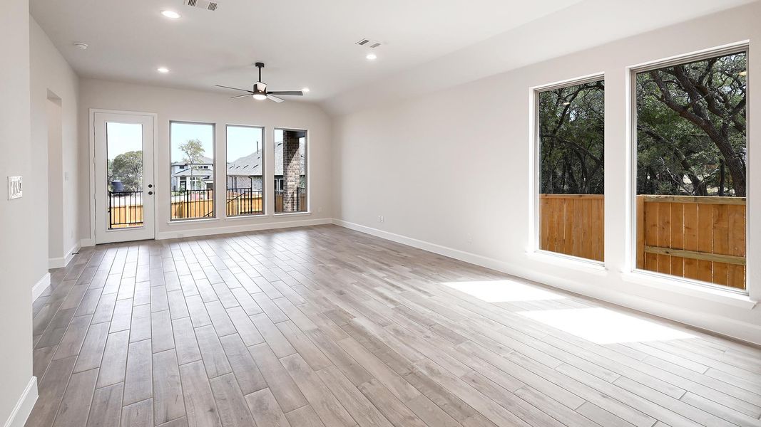 Unfurnished living room featuring recessed lighting, light wood finished floors, ceiling fan, and vaulted ceiling