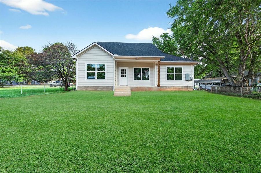 Back of property with a shingled roof Back of property with a shingled roof