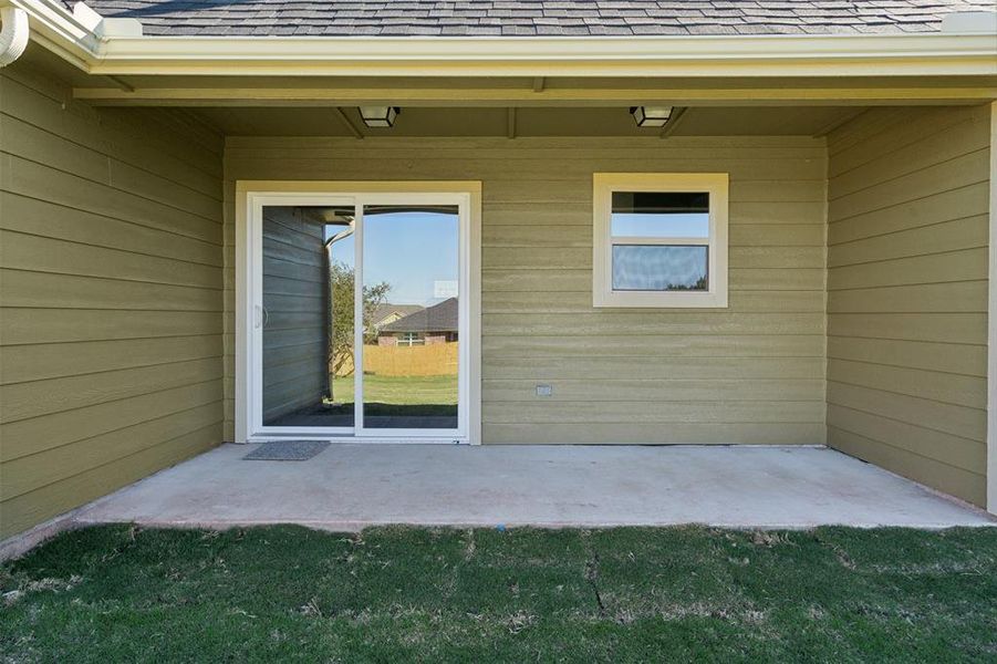 Doorway to property with a patio area