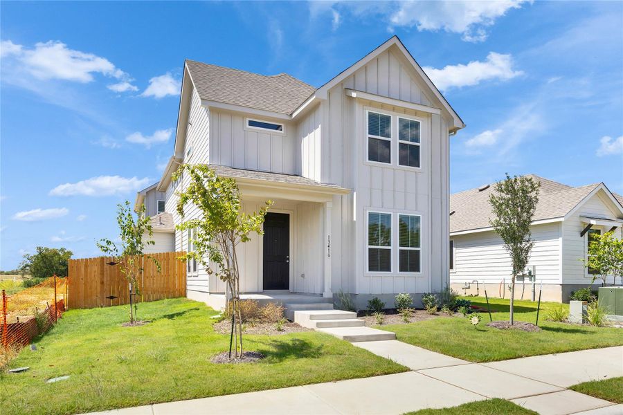 Modern inspired farmhouse with board and batten siding and a shingled roof