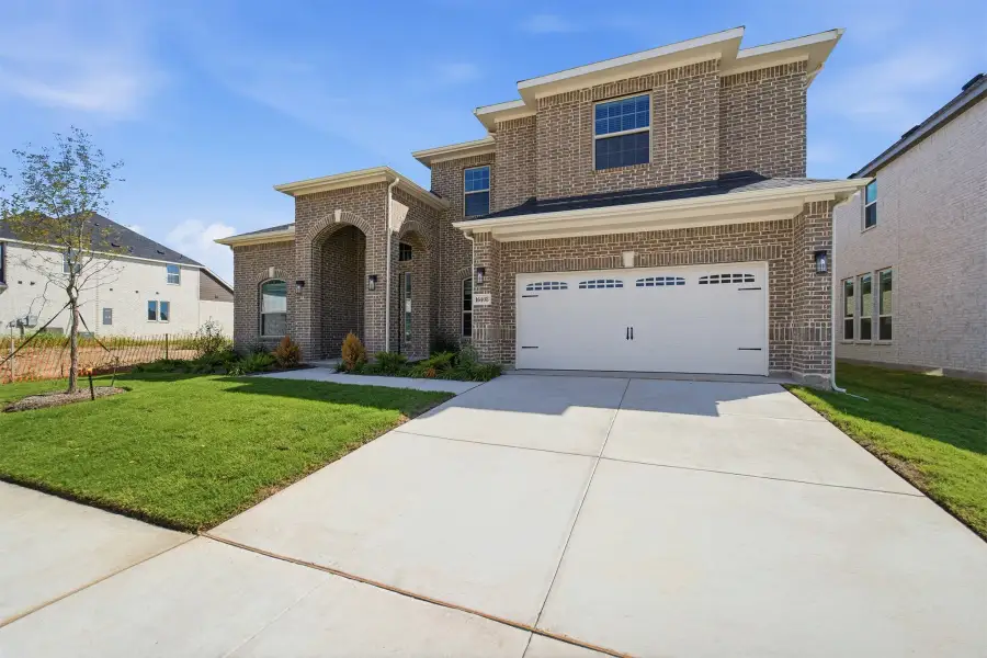 Front exterior of a new home in Green Meadows, Celina, TX, highlighting curb appeal (Image 27).