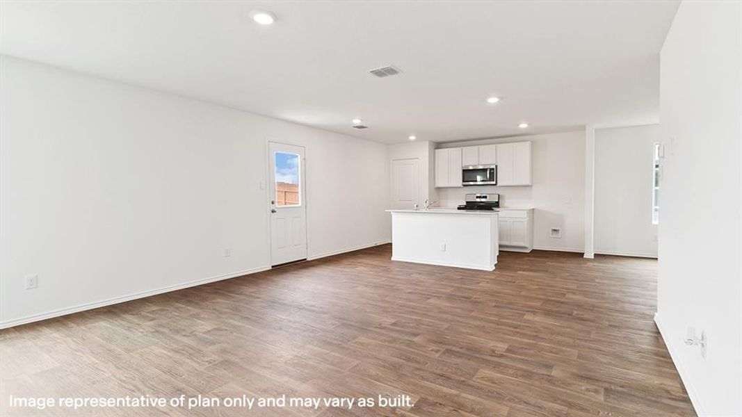 Kitchen featuring a kitchen island with sink, light countertops, white cabinetry, open floor plan, and dark wood-style floors