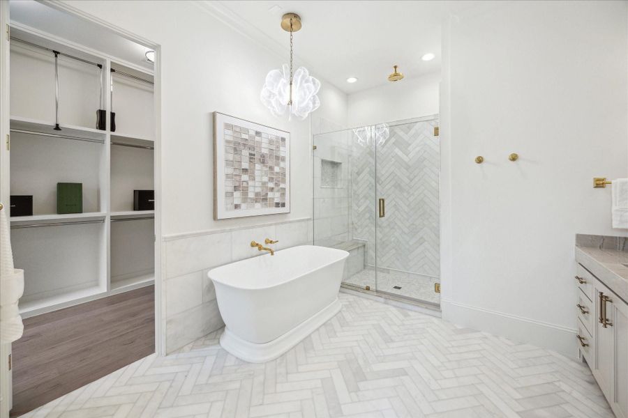 Primary bathroom to feature a soaking tub with Kallista wall-mounted faucet and framed glass shower with Laticrete shower system. **Photo is of another home in the community and for information purposes only. Buyer to verify all details.** Primary bathroom to feature a soaking tub with Kallista wall-mounted faucet and framed glass shower with Laticrete shower system. **Photo is of another home in the community and for information purposes only. Buyer to verify all details.**