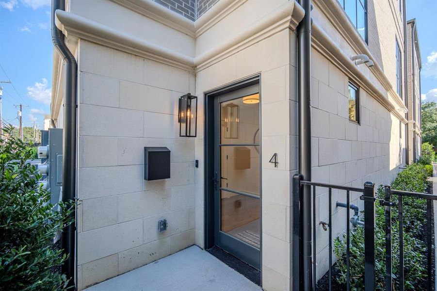Property entrance featuring concrete block siding