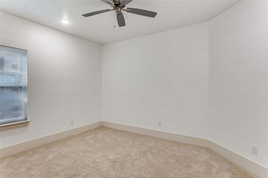 Empty room featuring light colored carpet, recessed lighting, and a ceiling fan Empty room featuring light colored carpet, recessed lighting, and a ceiling fan