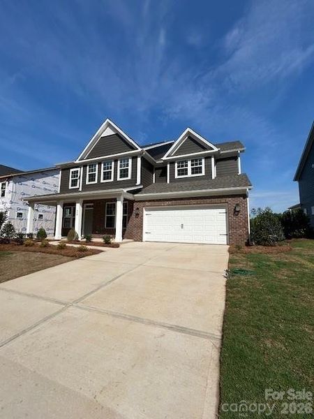 Front exterior of a new home in Michaux Gardens, Belmont, NC, highlighting curb appeal (Image 1). Front exterior of a new home in Michaux Gardens, Belmont, NC, highlighting curb appeal (Image 1).