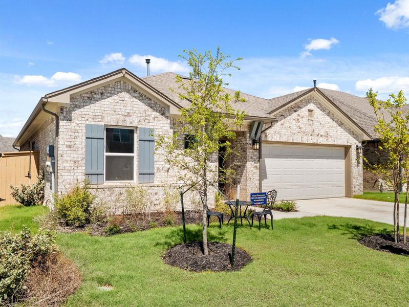 Front exterior of a new home in The Colony, Bastrop, TX, highlighting curb appeal (Image 1). Front exterior of a new home in The Colony, Bastrop, TX, highlighting curb appeal (Image 1).