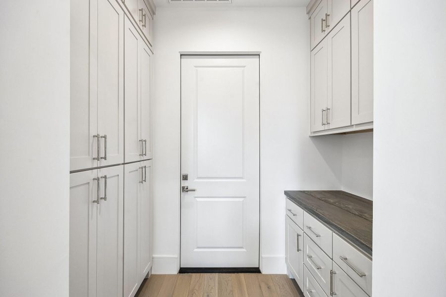 Mud room or "drop zone" located between the kitchen and garage with pantry storage.