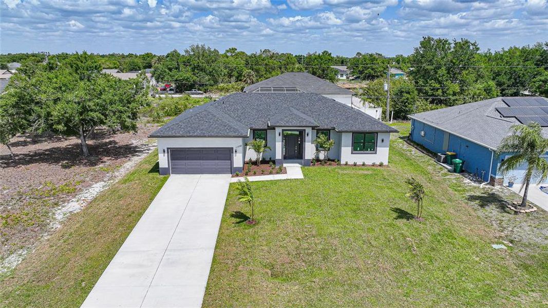 Front exterior of a new home in , Englewood, FL, highlighting curb appeal (Image 24).