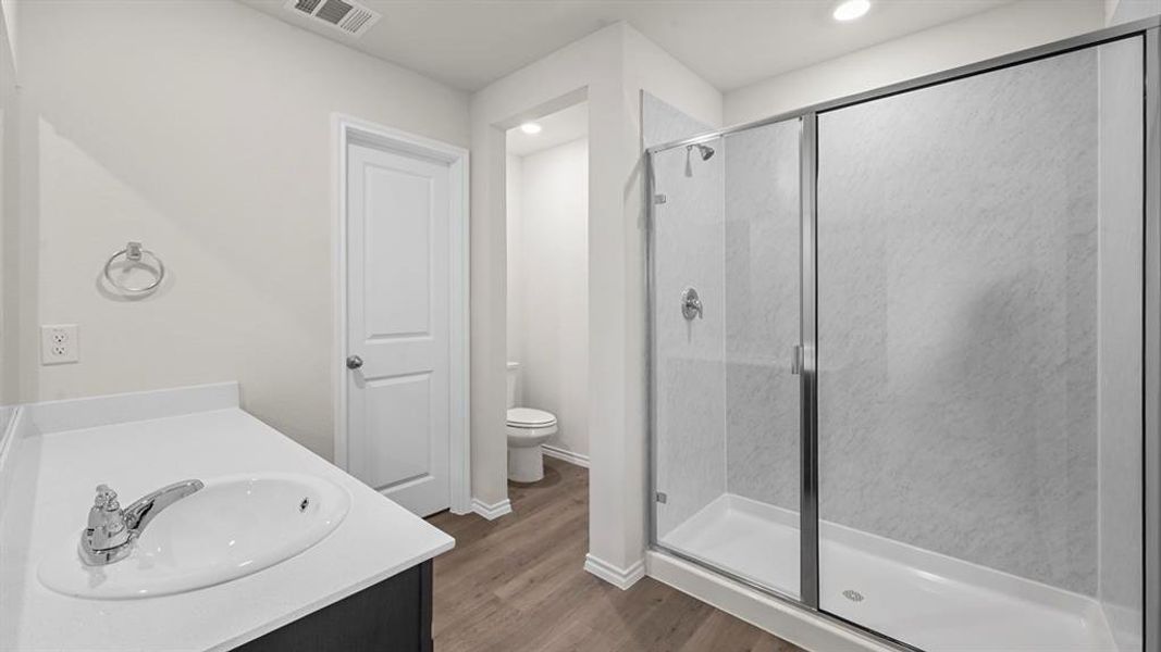 Full bathroom with vanity, a stall shower, dark wood finished floors, and recessed lighting
