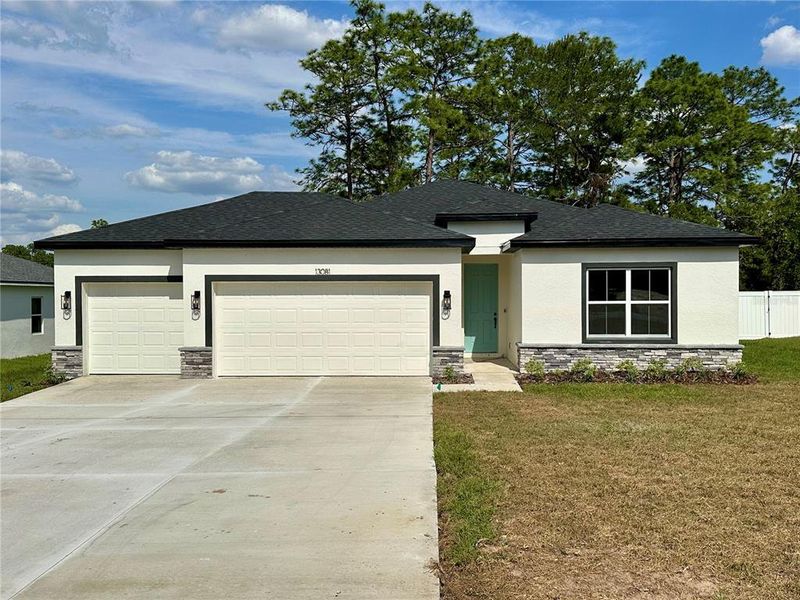 Front exterior of a new home in , Ocala, FL, highlighting curb appeal (Image 1).