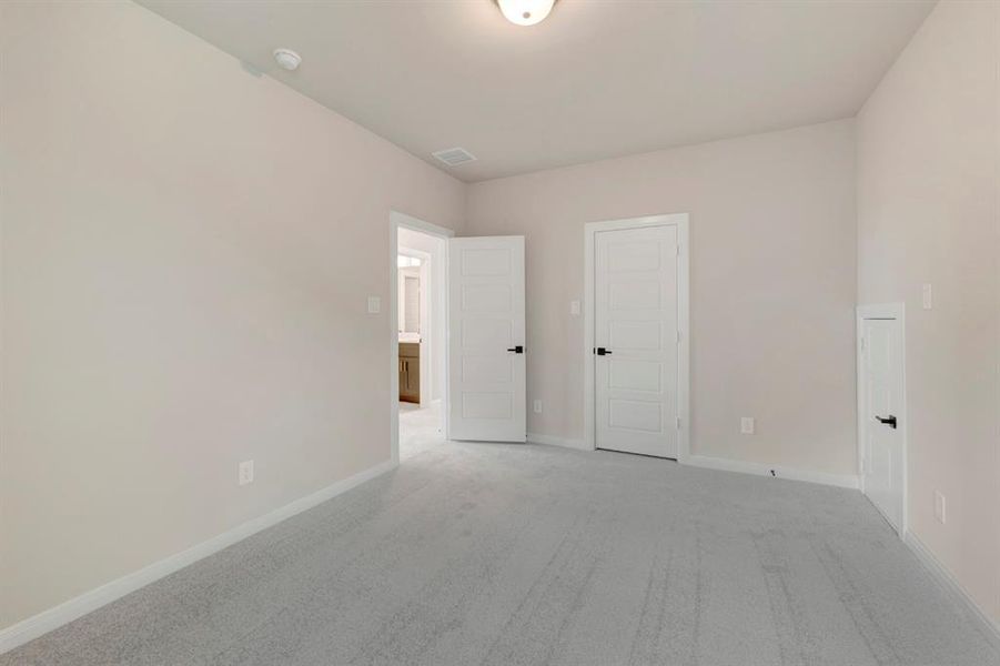 Unfurnished bedroom featuring carpet flooring and baseboards