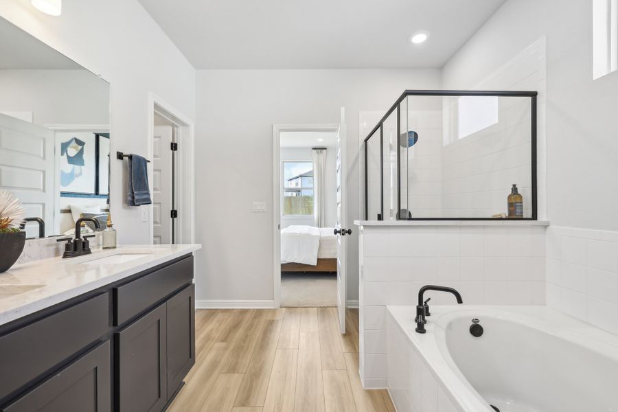 A bathroom with a tub and sink. A bathroom with a tub and sink.