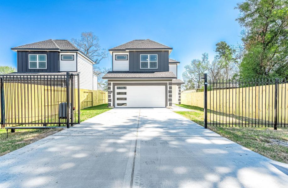 Modern two-story home with gated driveway entry and a spacious two-car garage. Modern two-story home with gated driveway entry and a spacious two-car garage.