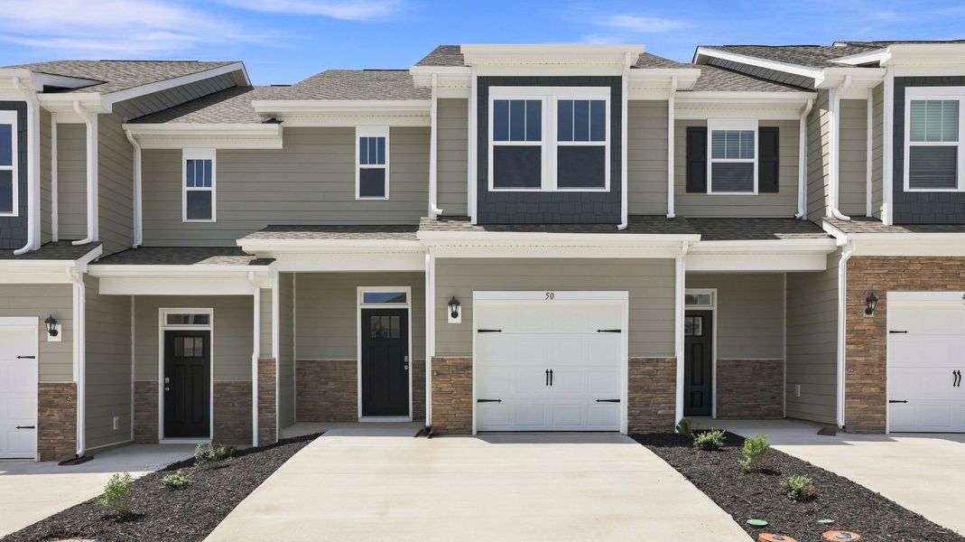 Front exterior of a new home in Townes at Tap Root Farms, Fletcher, NC, highlighting curb appeal (Image 1). Front exterior of a new home in Townes at Tap Root Farms, Fletcher, NC, highlighting curb appeal (Image 1).