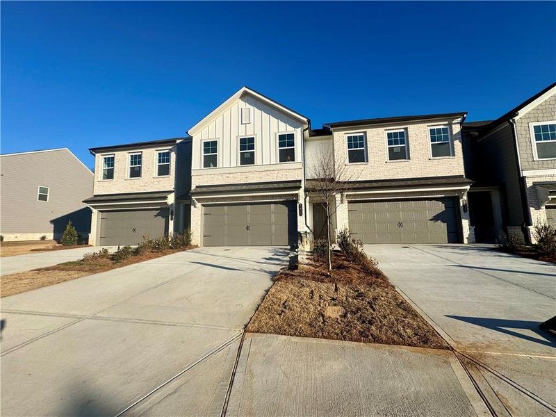 Front exterior of a new home in Eastlyn Crossing, Flowery Branch, GA, highlighting curb appeal (Image 16). Front exterior of a new home in Eastlyn Crossing, Flowery Branch, GA, highlighting curb appeal (Image 16).