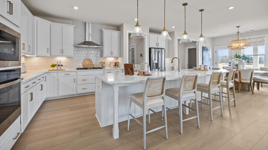 The Stonefield Home Plan by DRB Homes in Belmont, NC. - Kitchen featuring an oversized bar and butler's panty