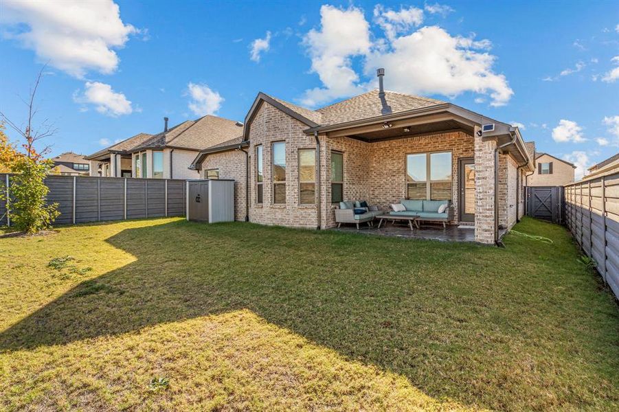 Back of house featuring a lawn and an outdoor hangout area