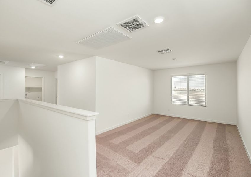 Second-floor game room with open railing and carpet in Wellton floor plan