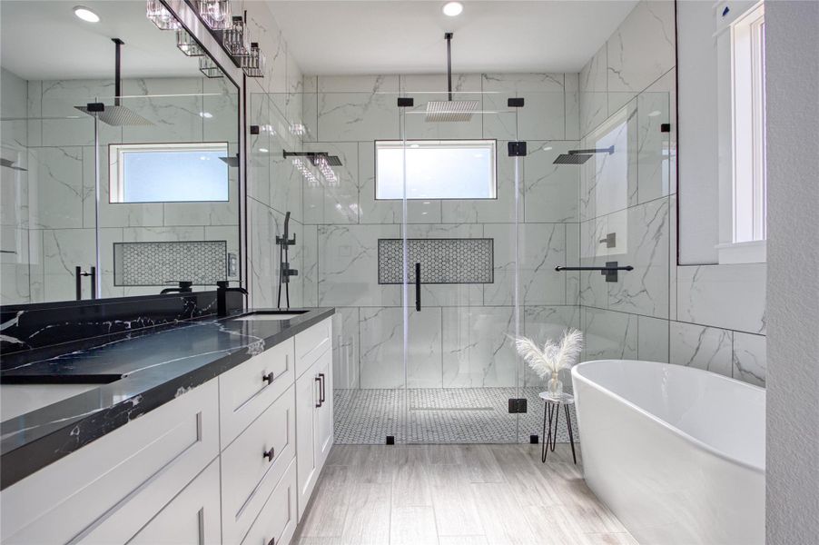 Primary bath features double sinks, plenty of cabinets and drawers, unbelievable shower with two shower heads and large soaking tub.