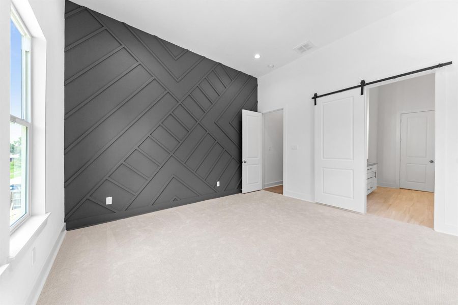Primary room featuring a stylish accent wall that adds character and depth to the space.