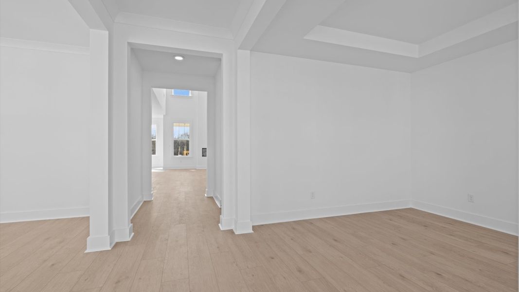 Memorable arrival experience with hardwood floors and elegant trim in the foyer