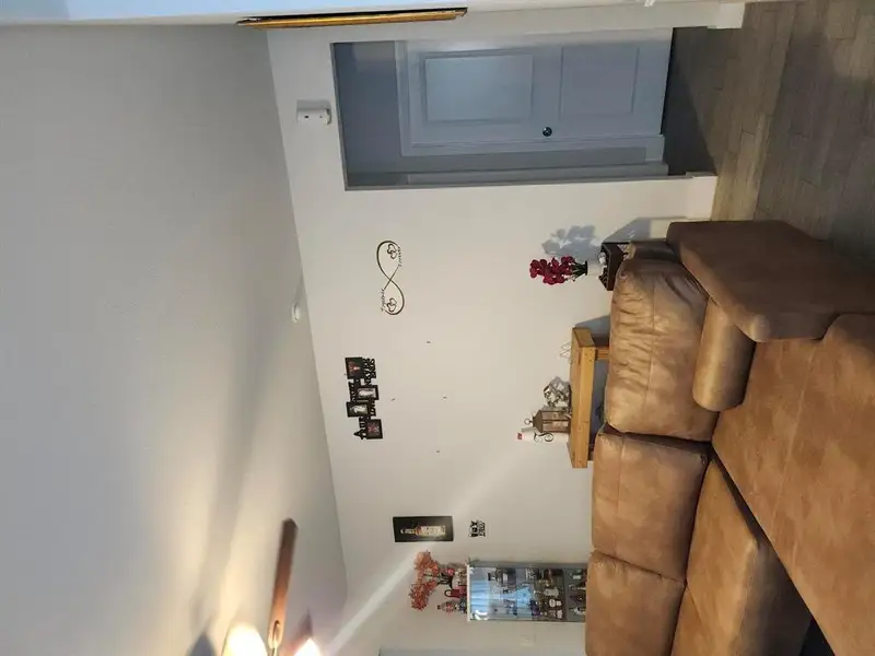Living room with dark wood finished floors and ceiling fan