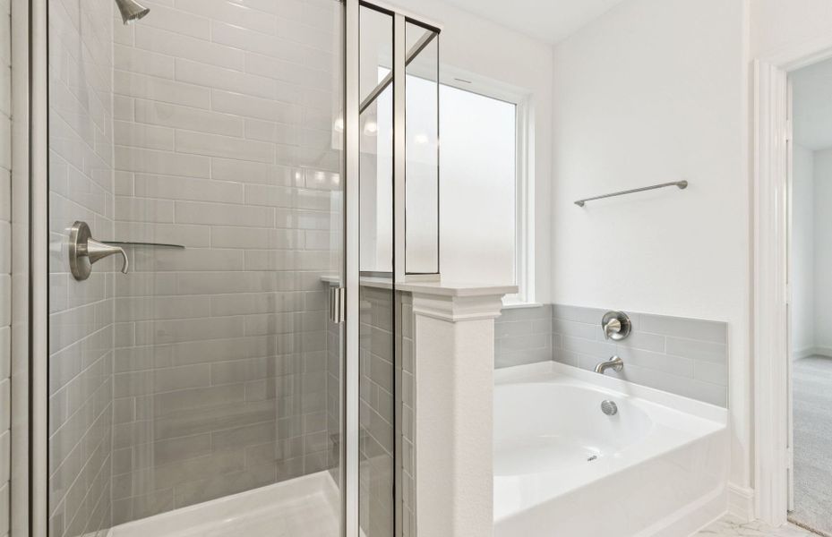 Owner's suite bath with a luxurious deep walk-in shower  *Real home pictured