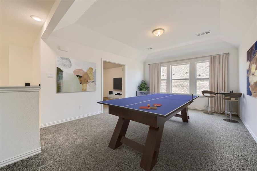 Virtually Staged Photo - Rec room featuring dark colored carpet