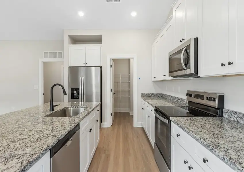 The kitchen has designer wood cabinetry