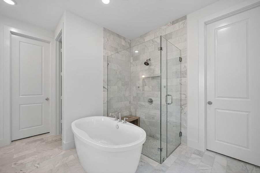 Full bathroom with a shower stall, light marble finish flooring, a soaking tub, and recessed lighting Full bathroom with a shower stall, light marble finish flooring, a soaking tub, and recessed lighting