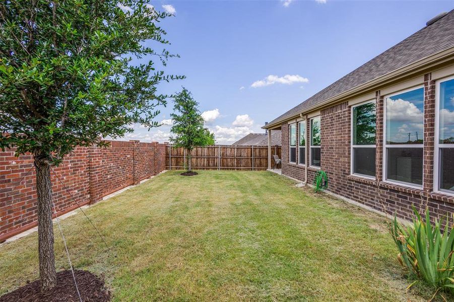 Private backyard with upgraded brick fence Private backyard with upgraded brick fence