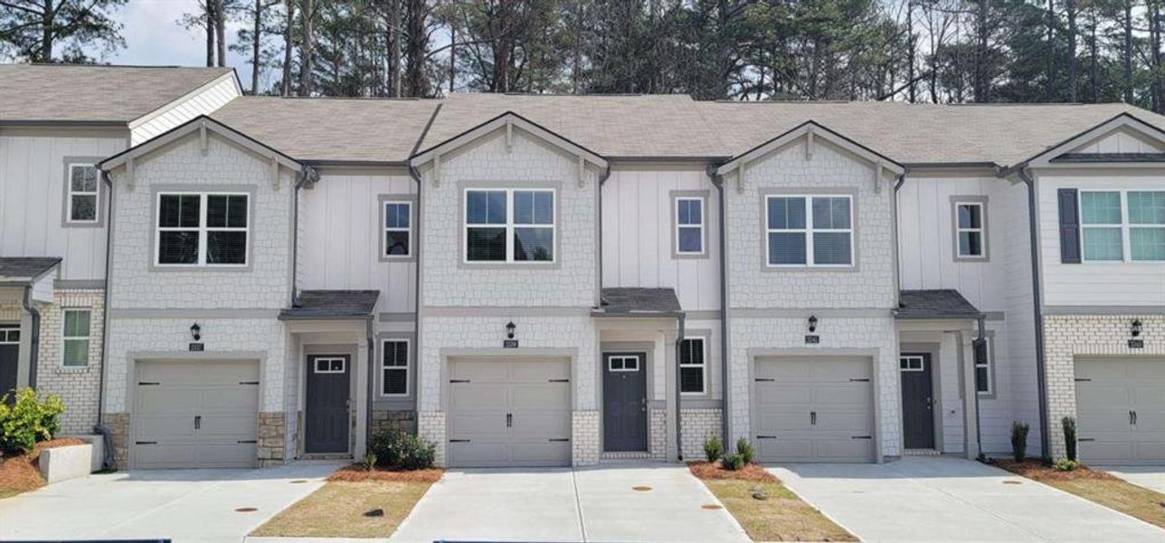 Front exterior of a new home in Wellington Park, Lithonia, GA, highlighting curb appeal (Image 1). Front exterior of a new home in Wellington Park, Lithonia, GA, highlighting curb appeal (Image 1).