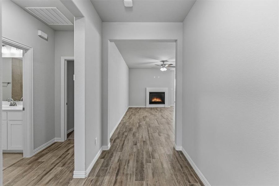 Corridor featuring light wood-type flooring and baseboards