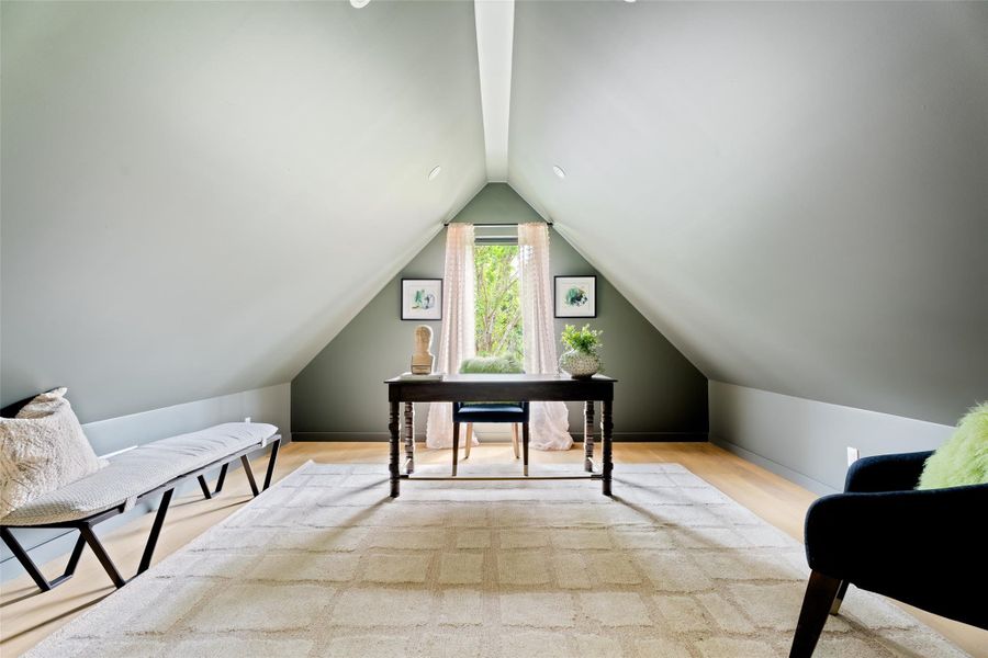 Office featuring vaulted ceiling and wood finished floors
