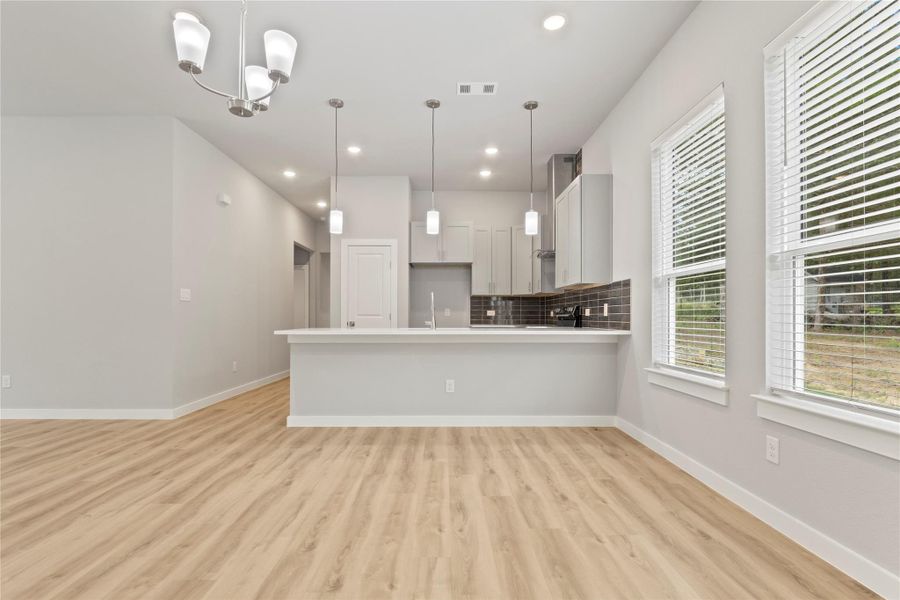 View of gorgeous cozy modern kitchen and dining area.