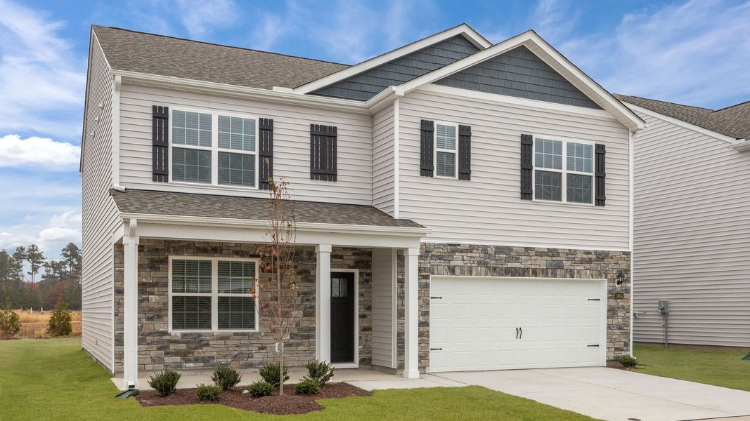 Front exterior of a new home in Ridgewood Farms, Winterville, NC, highlighting curb appeal (Image 20). Front exterior of a new home in Ridgewood Farms, Winterville, NC, highlighting curb appeal (Image 20).