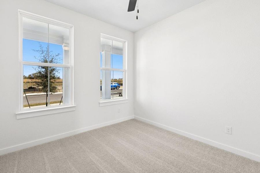 Empty room featuring carpet and ceiling fan