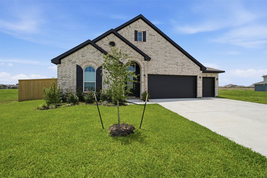Front exterior of a new home in River Ranch Meadows, Dayton, TX, highlighting curb appeal (Image 27).